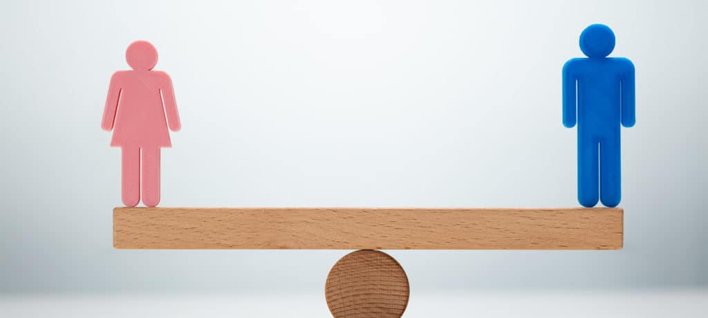 gender equality represented by male and female figure on each end of a seesaw