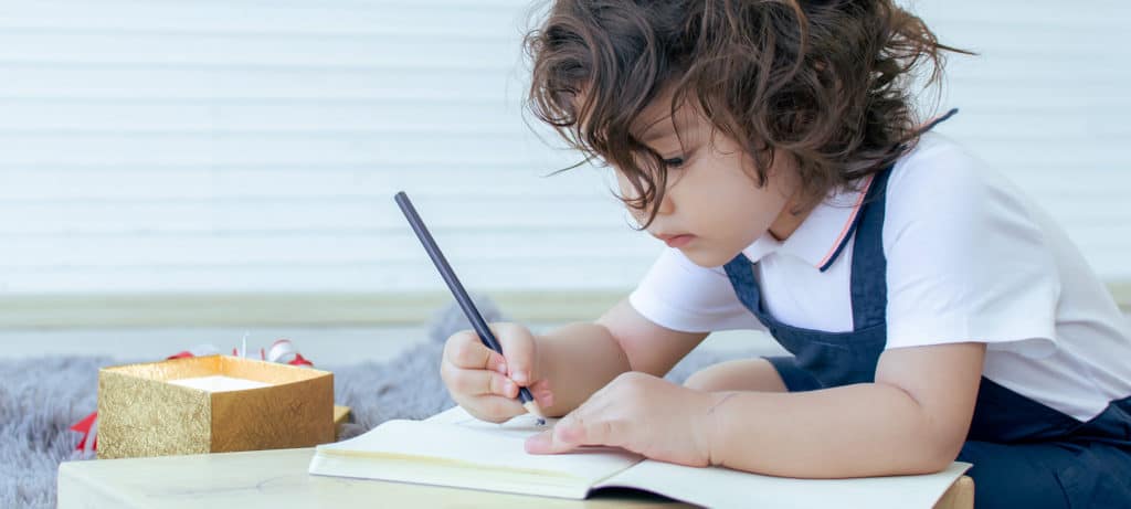 Child draws on paper