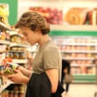 Man stands in aisle reading food labels