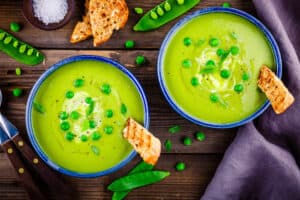 Green,Pea,Soup,With,Croutons,On,Wooden,Rustic,Background